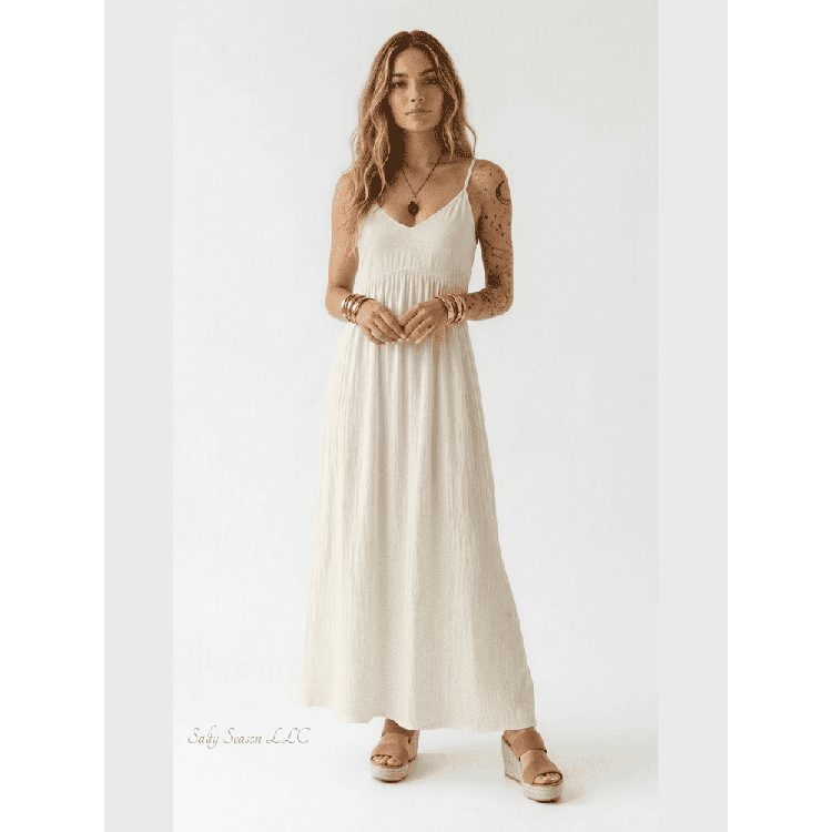 Cream sleeveless boho maxi dress with V-neck and pleated skirt on model