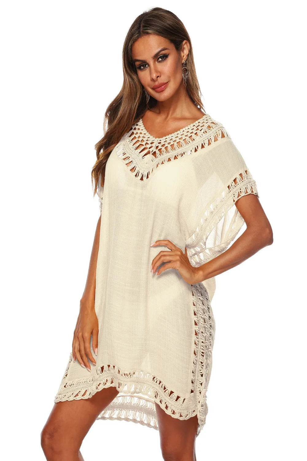 Woman wearing a white crochet dress on a white background