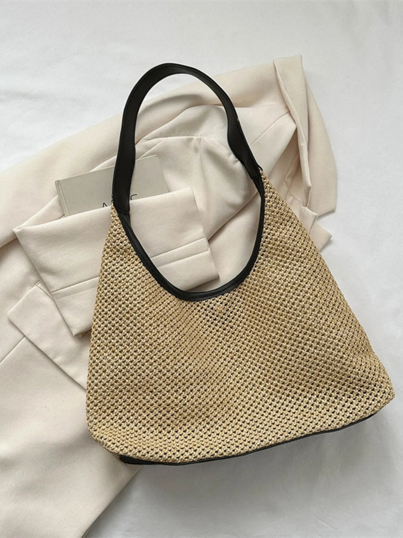 Woven Straw Shoulder Bag on white counter