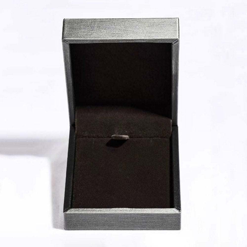 Open textured jewelry box with black velvet interior lining