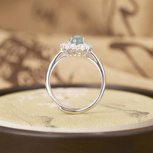 Silver ring with a gemstone on a textured surface