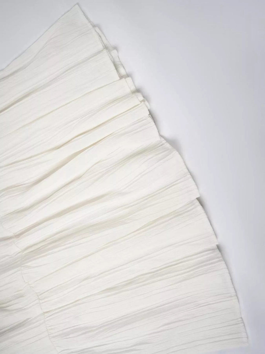 White Ruched tiered fabric on white table