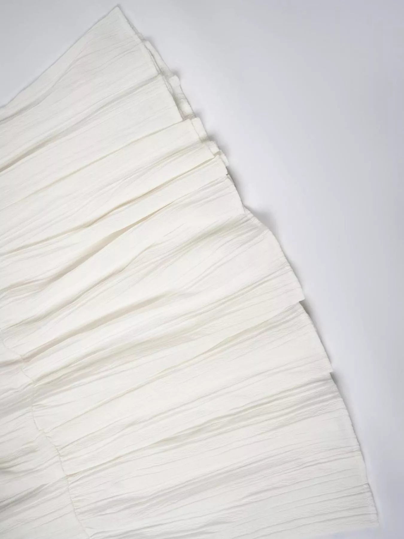 White Ruched tiered fabric on white table