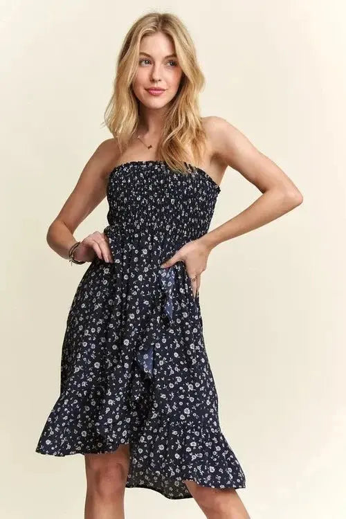 Woman wearing a strapless floral dress on a beige background