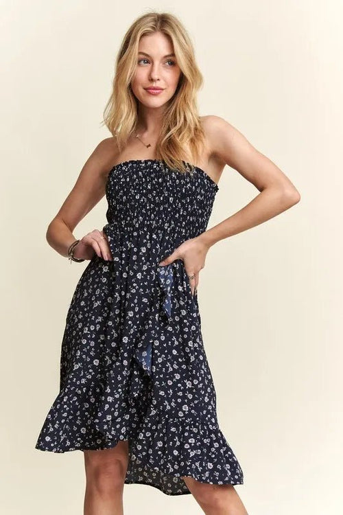 Woman wearing a strapless floral dress on a beige background
