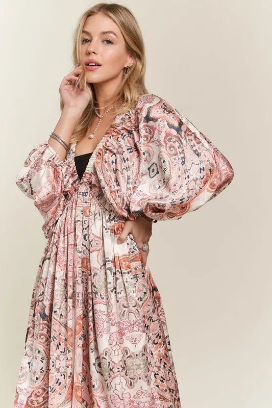 Woman wearing a floral patterned dress against a plain background