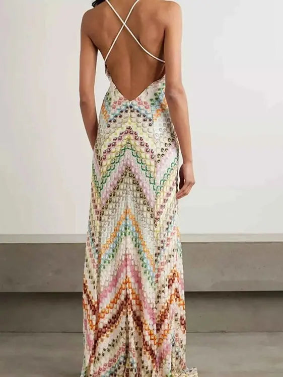 Multicolored patterned dress with open back on a plain background