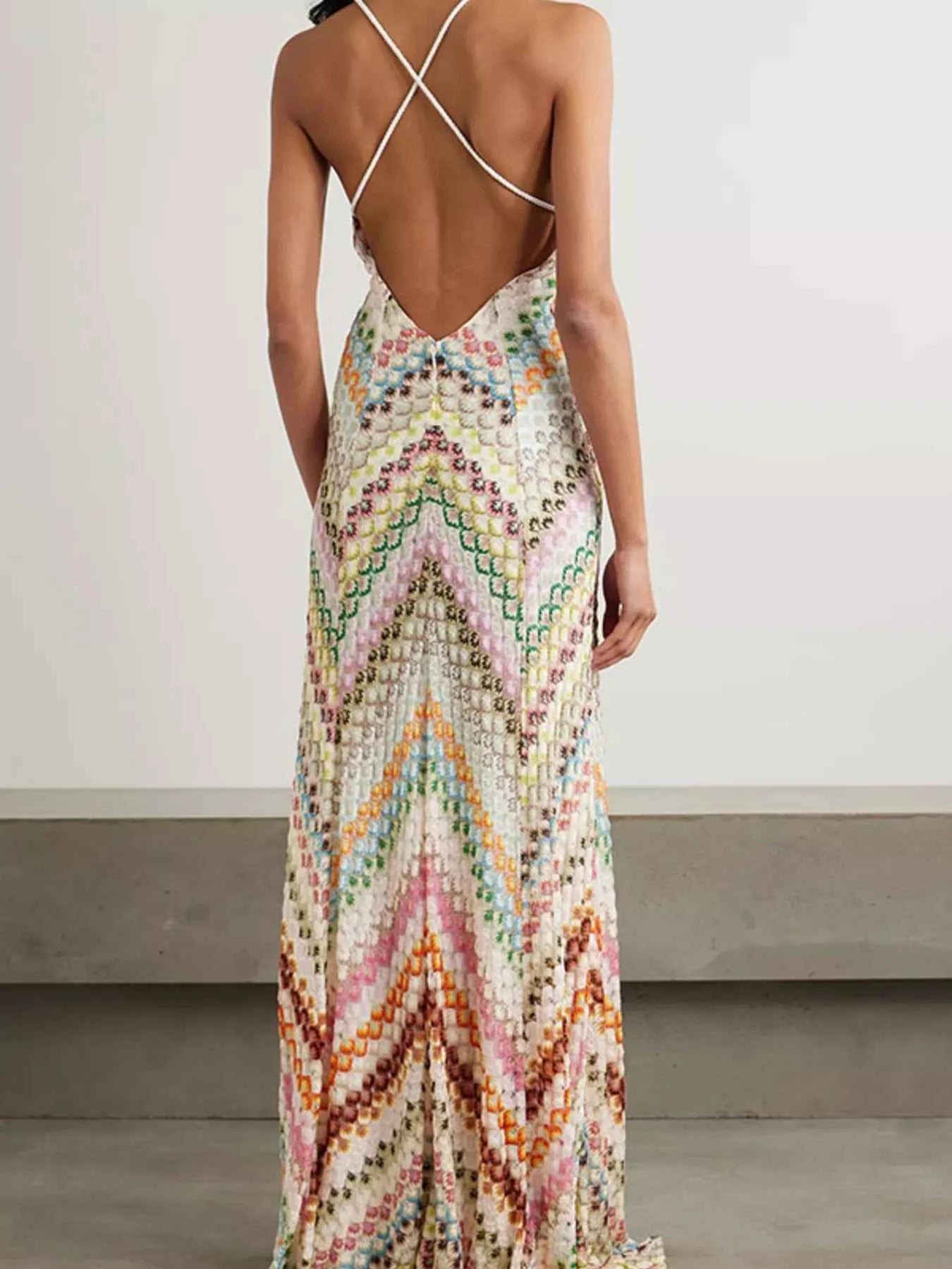 Multicolored patterned dress with open back on a plain background