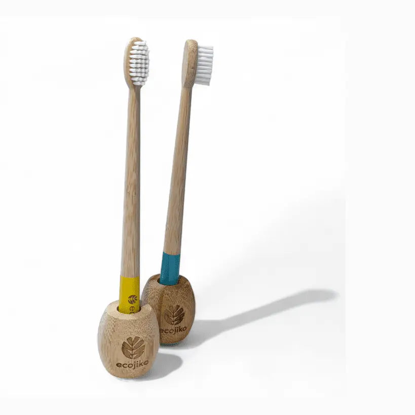 dual bamboo toothbrush holders with yellow and blue brushes