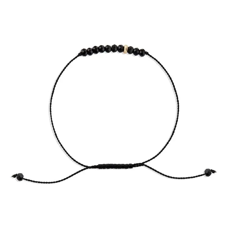 Black beaded bracelet on a white background