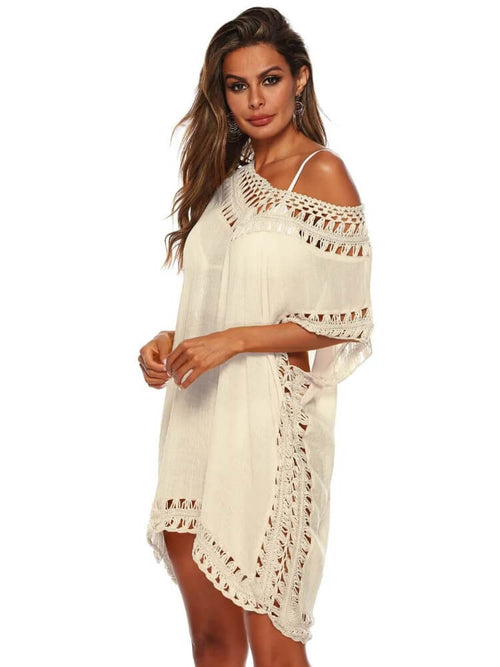 Woman wearing a white crochet cover-up dress on a white background