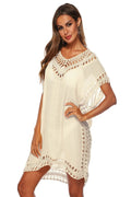 Woman wearing a white crochet dress on a white background