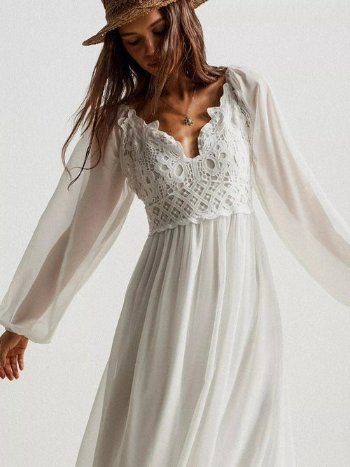 Close-up white crochet lace maxi dress scalloped V-neck floral pattern