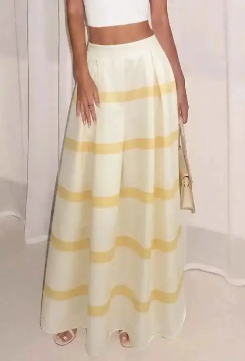 Side view of pleated yellow striped maxi skirt with clutch