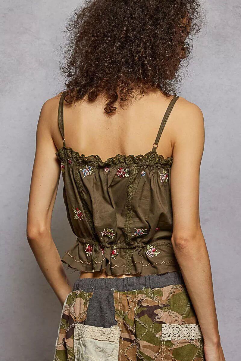 woman wearing brown embroidered top