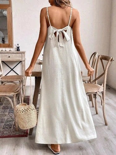 Back view of cream maxi dress with tie neckline detail