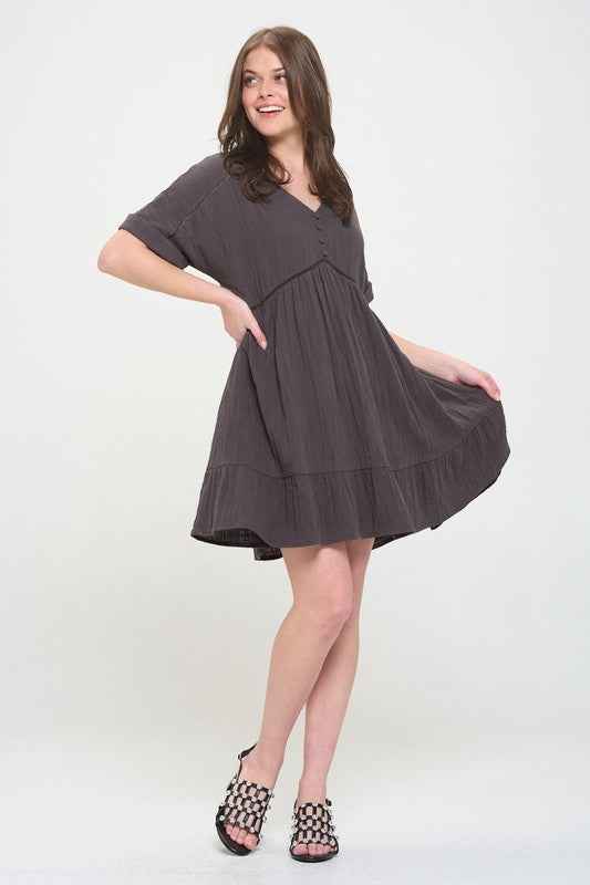 Woman wearing a dark gray dress on a white background
