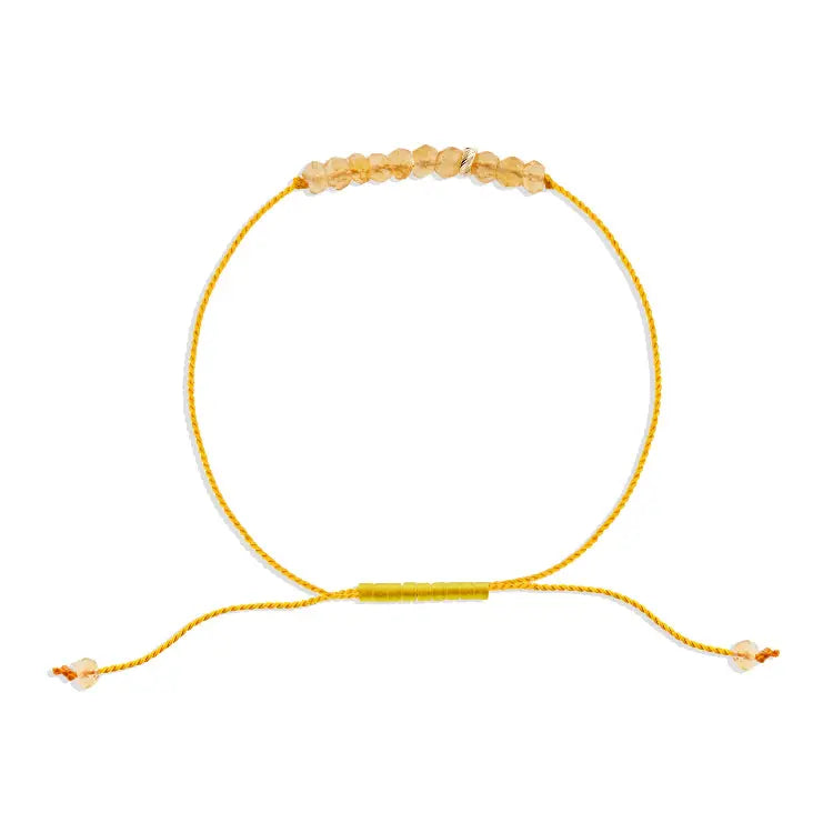 Yellow beaded bracelet on a white background