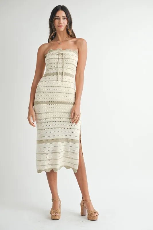 Woman wearing a strapless, patterned dress on a white background