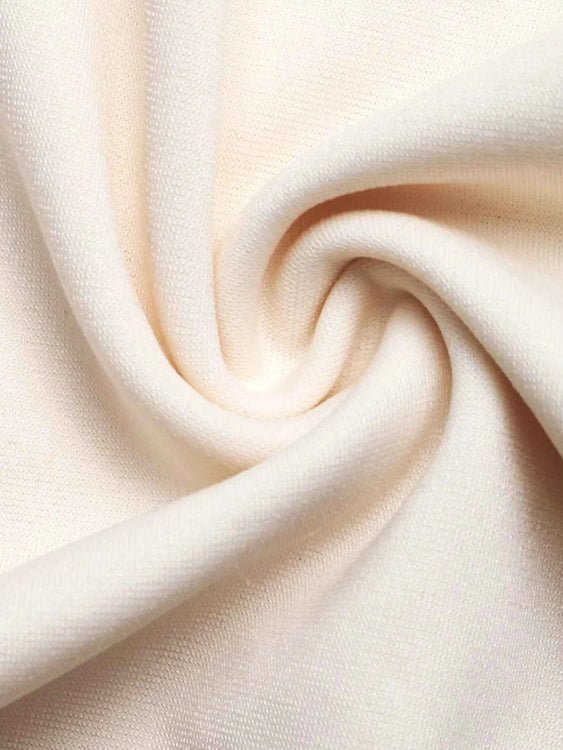Close-up of beige fabric with a swirl pattern
