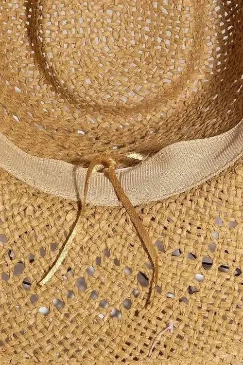 Inside crown of tan straw hat showing ribbed band and gold cord