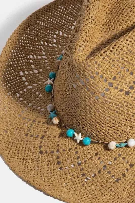 Close-up of turquoise round and star bead strap on straw hat