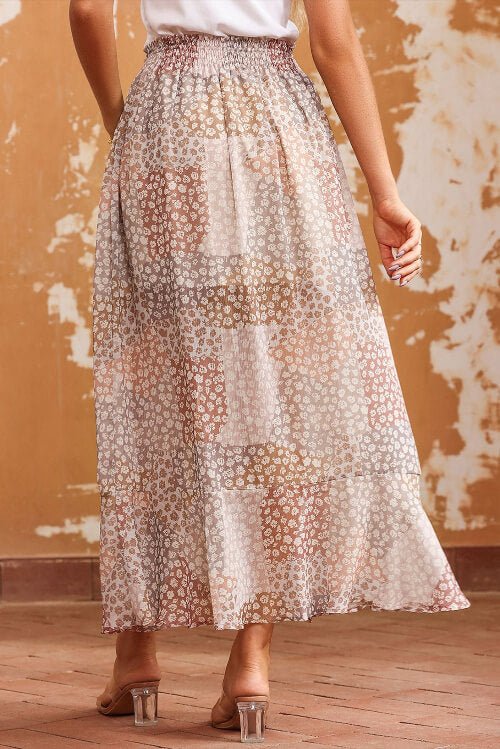 Person wearing a floral skirt with a textured wall background