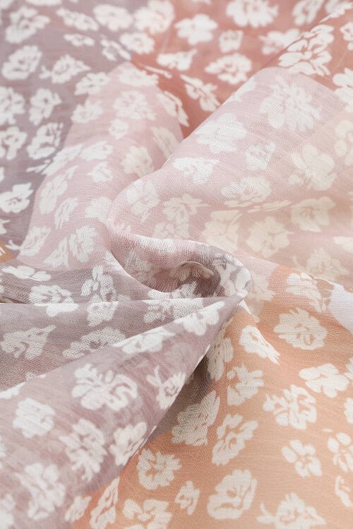 Close-up of pink floral fabric with a soft texture