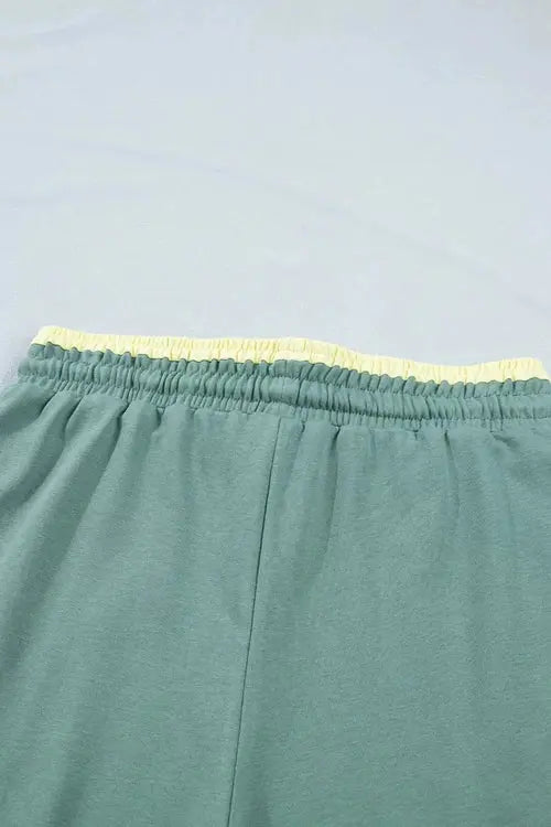 Green pants with flower on right thigh and left shin