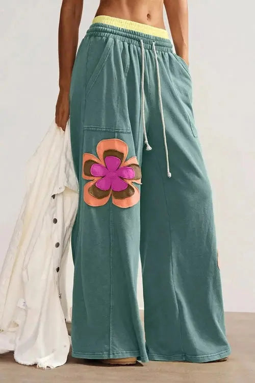 Green pants with flower on right thigh and left shin