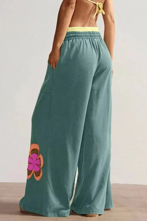 Green pants with flower on right thigh and left shin