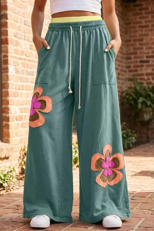 Green pants with flower on right thigh and left shin