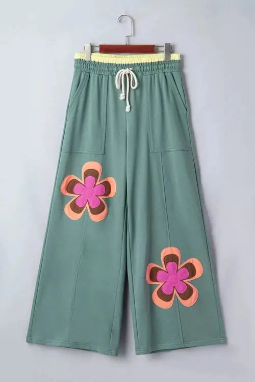 Green pants with flower on right thigh and left shin