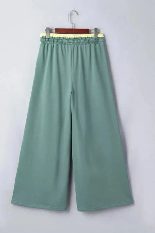 Green pants with flower on right thigh and left shin