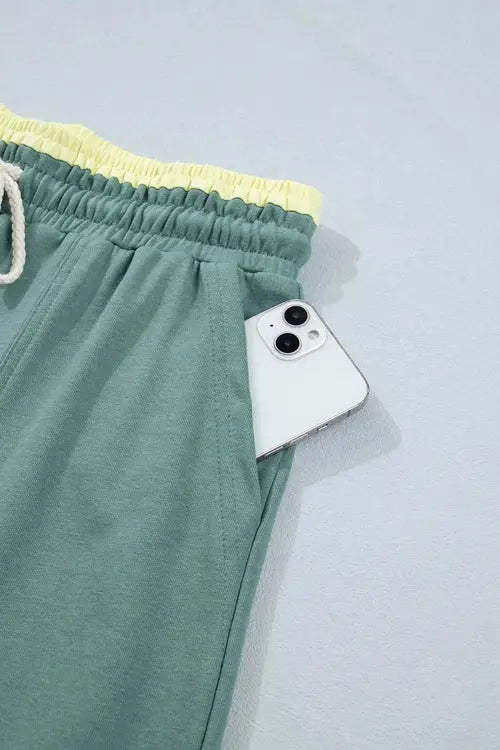 Green pants with flower on right thigh and left shin
