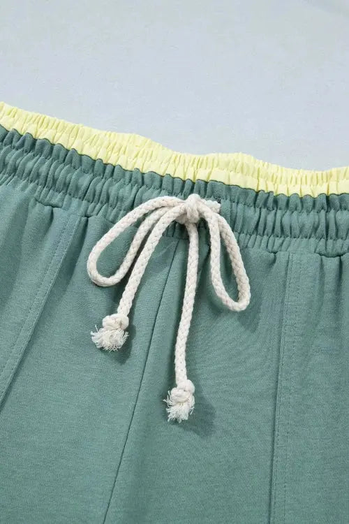 Green pants with flower on right thigh and left shin