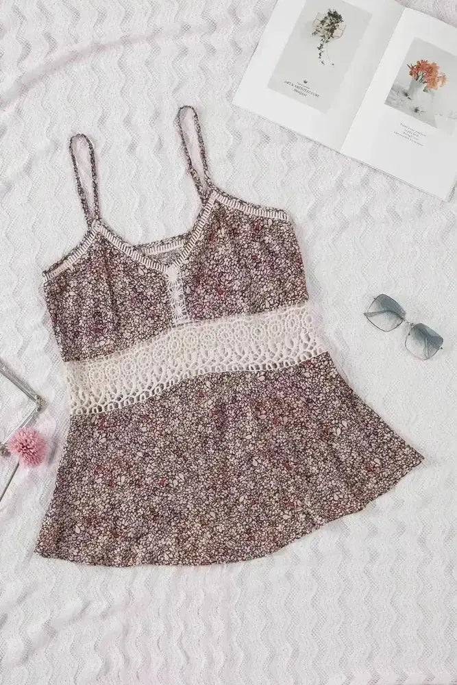 Floral dress with lace details on a textured surface with sunglasses and pink flower.