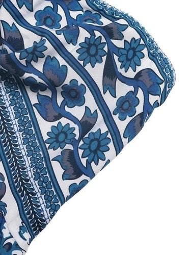 close-up blue floral pattern on white lightweight dress fabric