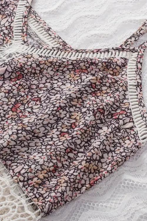Floral patterned fabric with white trim on a textured surface