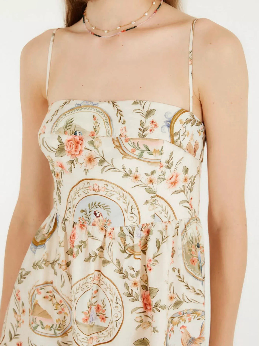 Floral and paisley patterned dress on a white background