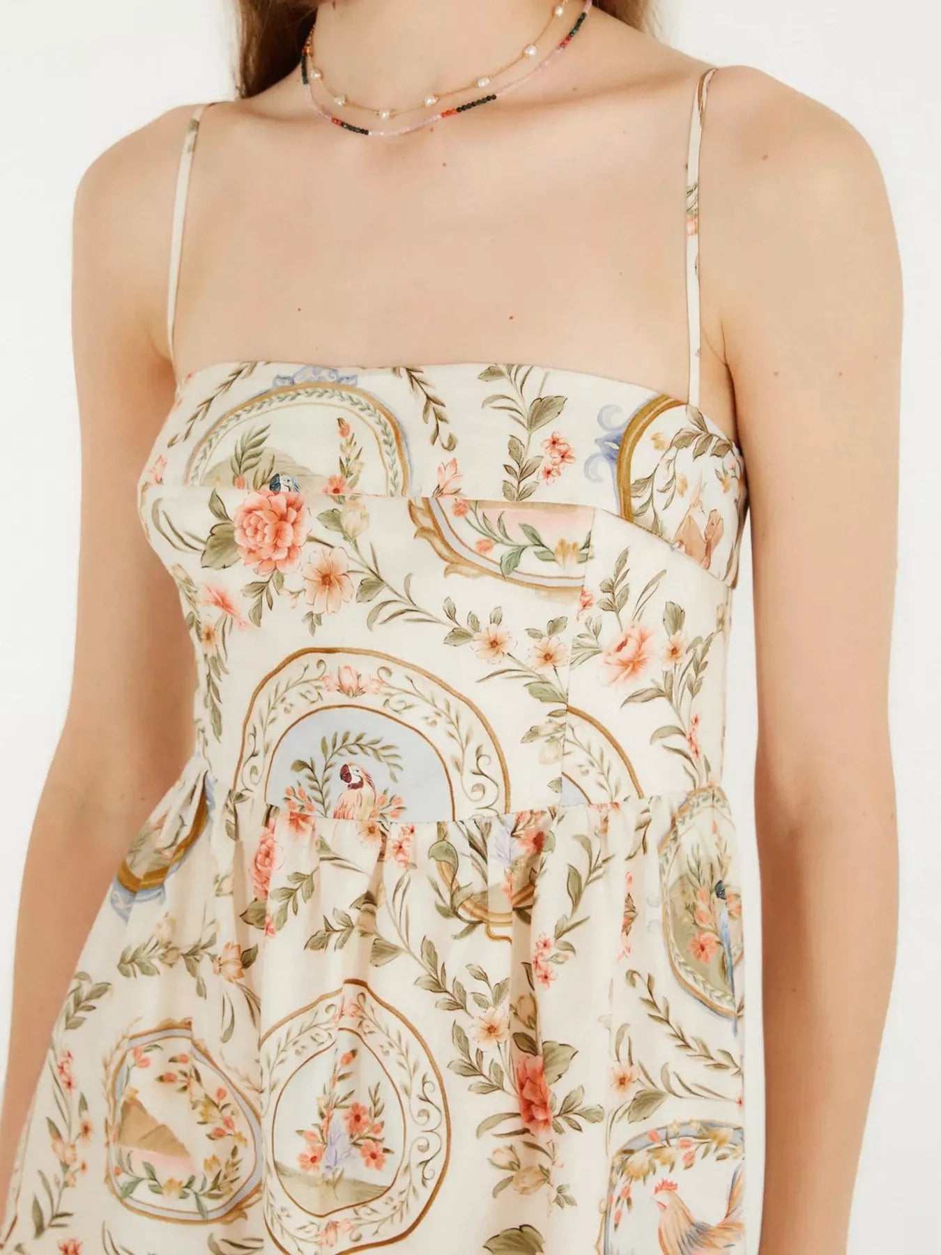 Floral and paisley patterned dress on a white background