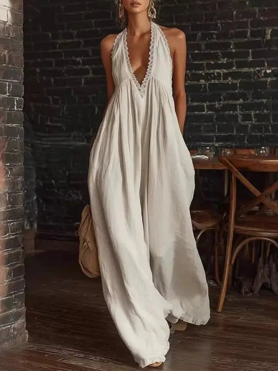 White halter neck jumpsuit with wide legs and lace trim on neckline