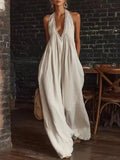 White halter neck jumpsuit with wide legs and lace trim on neckline