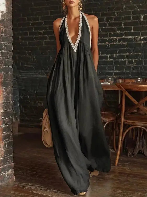 Black halter neck jumpsuit with white lace trim and wide legs