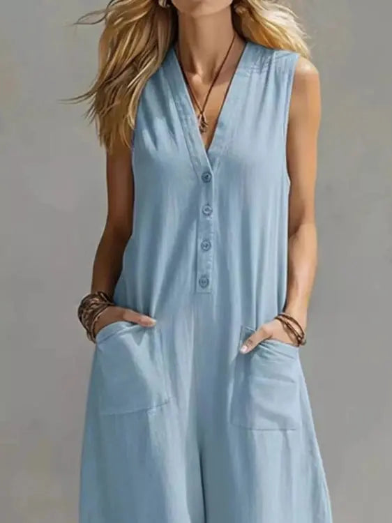 Light blue V-neck sleeveless wide-leg jumpsuit with dark buttons and flowing silhouette