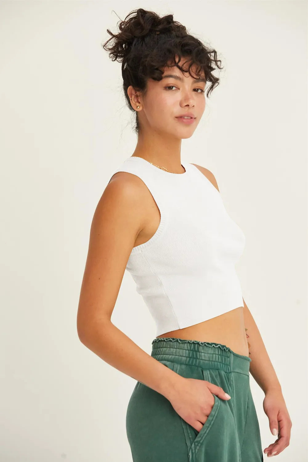 White ribbed knit cropped tank top side profile showing curved hemline