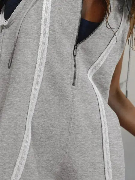 Gray sleeveless jacket with white accents on a person outdoors