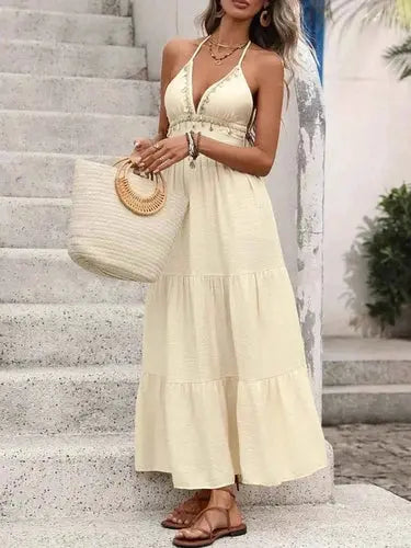 Cream halter neck maxi dress with ruffled tiers and shell details