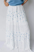 White floral skirt with blue flowers on a plain background