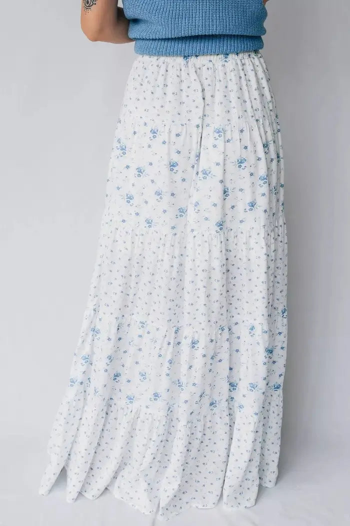 White floral skirt with blue flowers on a plain background